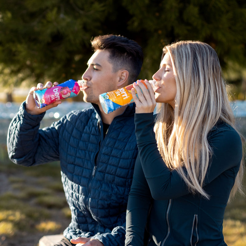 man and woman drinking berri fit