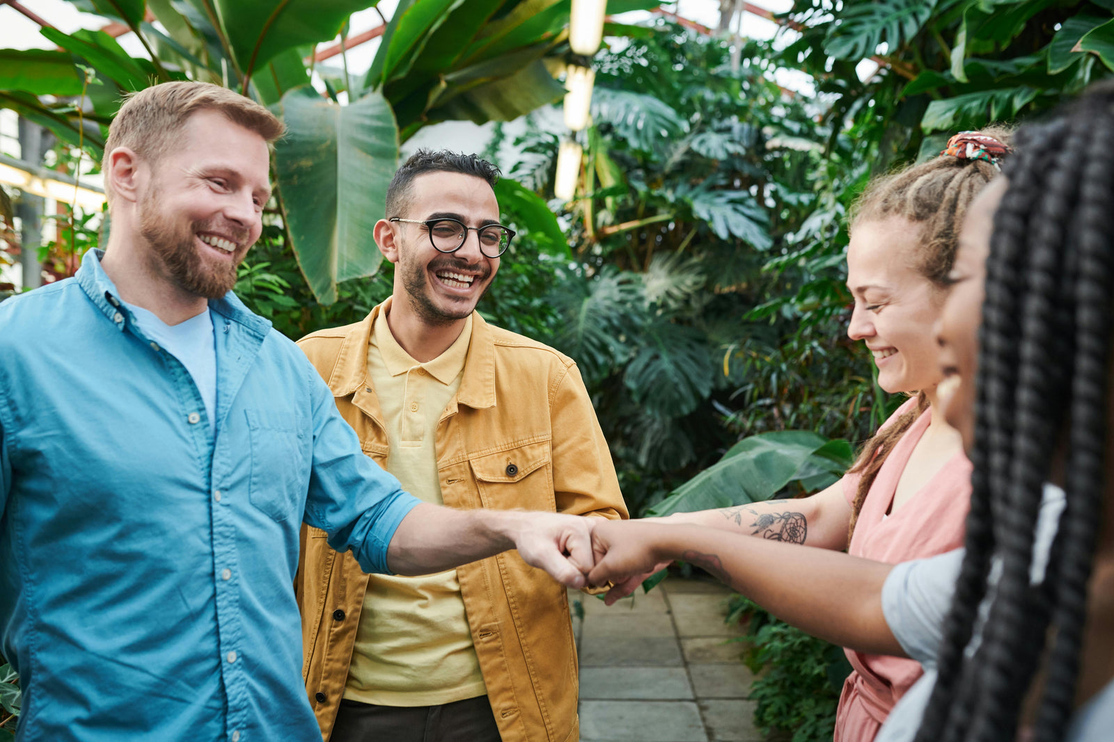 Fist bumping group | Berri Organics