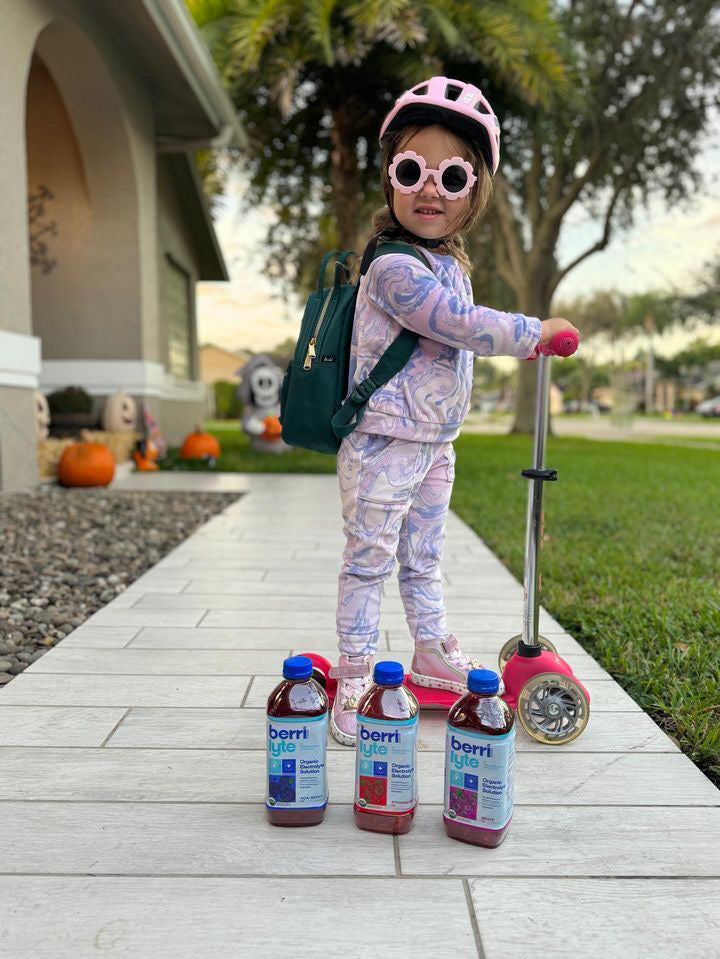 kid on scooter with sports drink