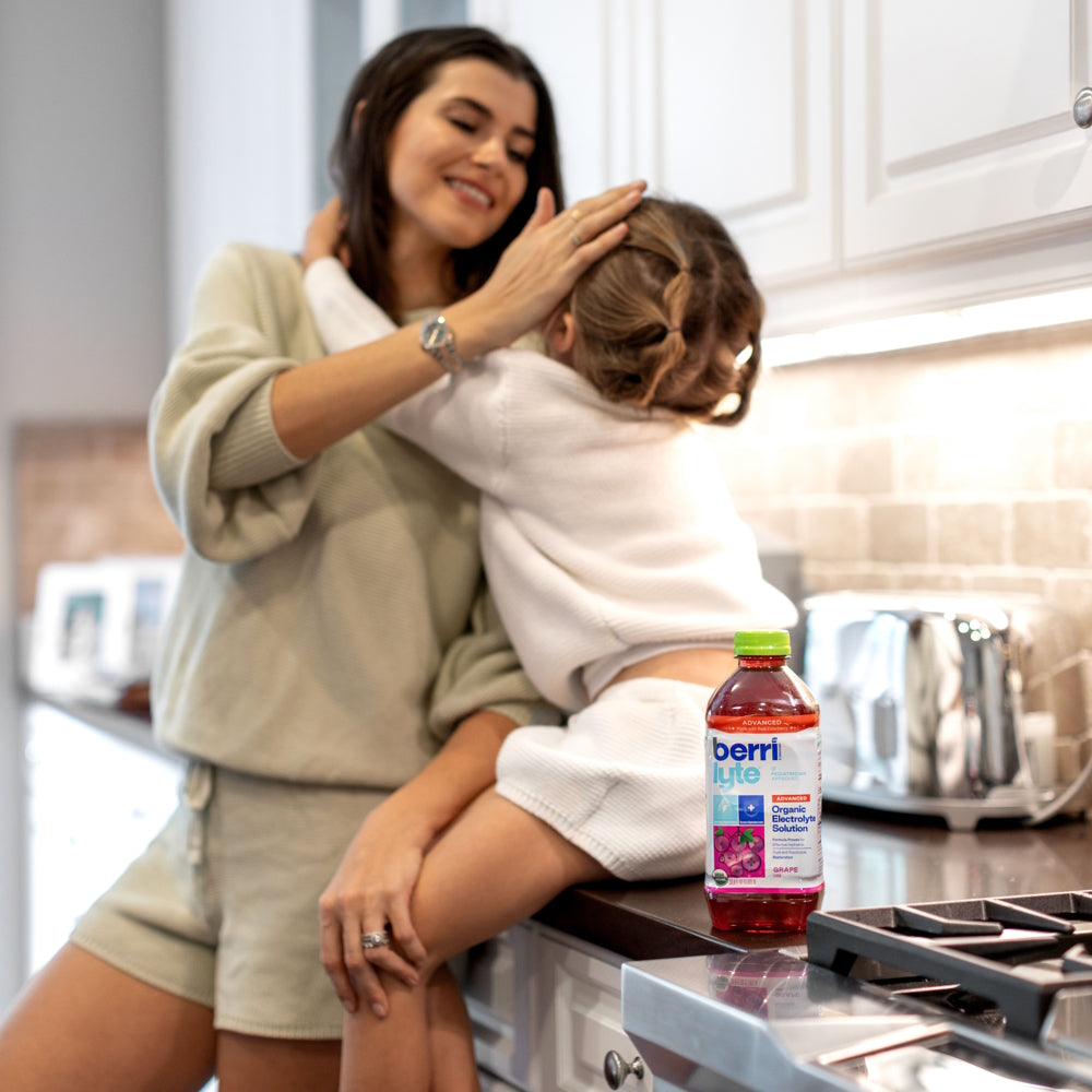 mom with daughter drinking a sports drink
